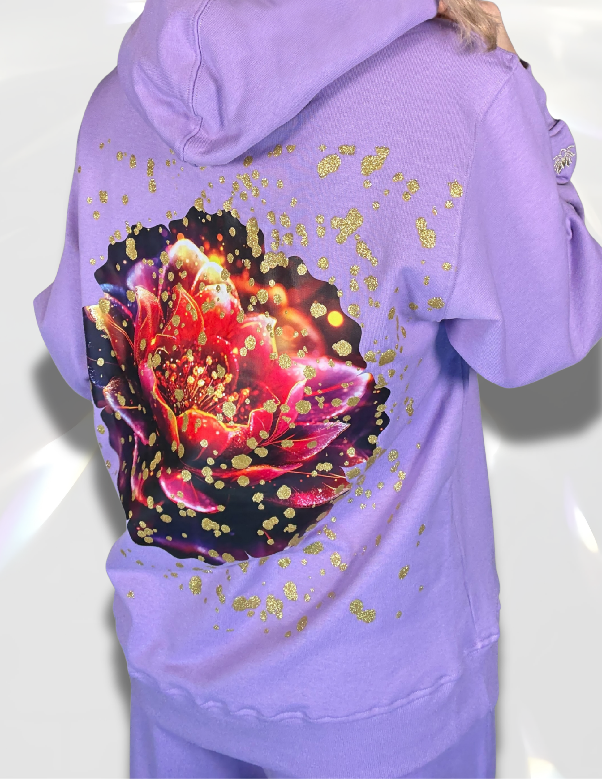 oversized hoodie with golden glitter print on top of large colorful lotus DTF print back view